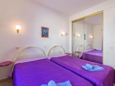 a bedroom with two beds and a mirror at Villa Flor de Maio by Interhome in Patroves
