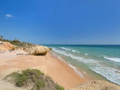 a beach with rocks and the ocean on a sunny day at Villa Flor de Maio by Interhome in Patroves