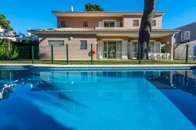a house with a swimming pool in front of a house at Villa with Garden and Pool in Vilamoura