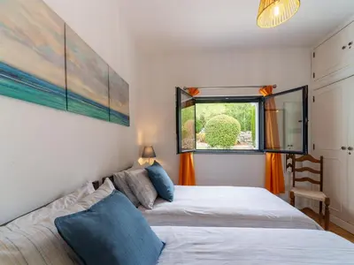 a bedroom with a bed and a window at Casa O Sonho near Faro with private pool in Santa Bárbara de Nexe