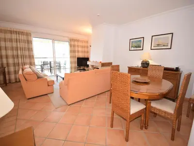 a living room with a couch and a table at Sunny Balcony Apartment and Pool in Vilamoura