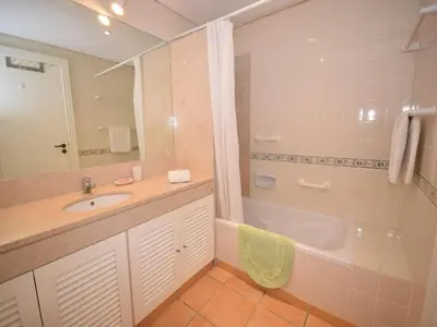 a bathroom with a sink and a bath tub at Sunny Balcony Apartment and Pool in Vilamoura