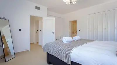 a bedroom with a bed with two pillows on it at Villa Natura - Varandas do Lago in Almancil