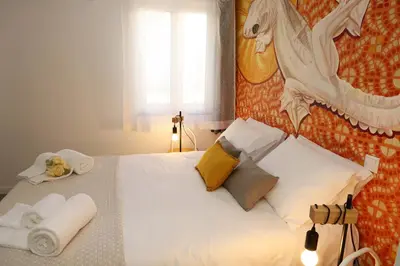 a bedroom with a white bed with a horse on the wall at Le Jardin Secret de Faro Guesthouse in Faro
