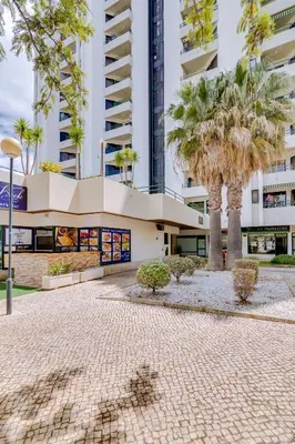 a living room with a blue couch and a tv at Tália - City Center - Vilamoura in Vilamoura