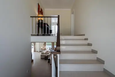 a staircase in a home with white stairs at Casa Lago in Quinta do Lago