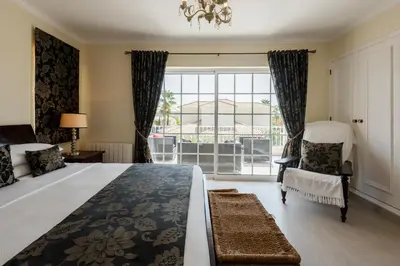 a bedroom with a large bed and a window at Casa Lago in Quinta do Lago