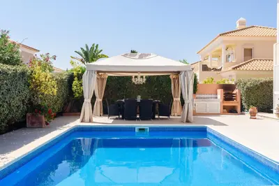 a gazebo and a swimming pool in a backyard at Casa Lago in Quinta do Lago