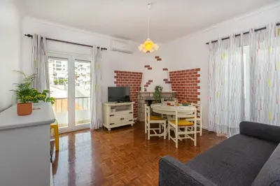 a living room with a couch and a table at T2 Apartamento do Tenis in Albufeira