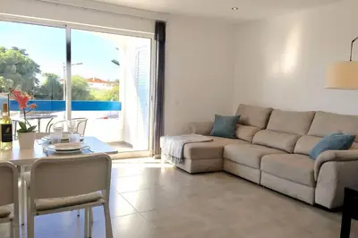 a living room with a couch and a table at Edifico Ouramar T2 in Albufeira