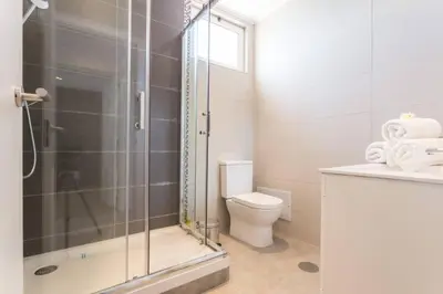 a bathroom with a shower and a toilet at Edifico Ouramar T2 in Albufeira