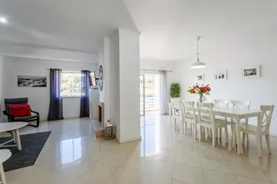 a dining room and living room with a table and chairs at Amazing apartment in Albufeira in Albufeira