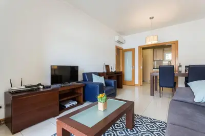 a living room with a couch and a tv at Quinta Barracuda in Albufeira