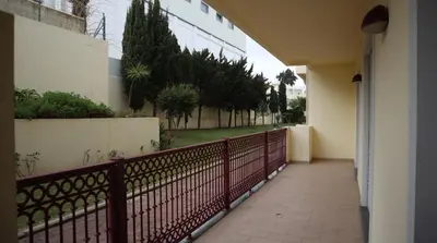 a balcony of a building with a fence and trees at Casablanca By Albufeira Rental in Albufeira