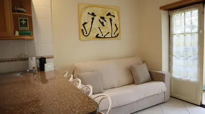 a living room with a couch and a table at Casablanca By Albufeira Rental in Albufeira