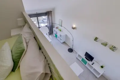 a small room with a bed and a window at Cruzeiro do Sul Apartments - Vilamoura center in Vilamoura