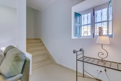 a living room with a couch and a window at Faro Tradicional House - City center in Faro