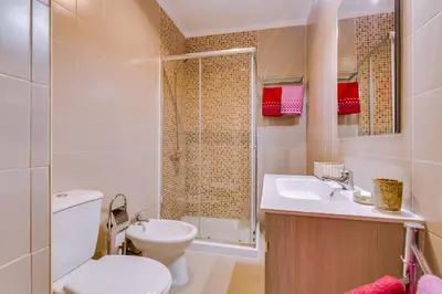 a bathroom with a toilet and a sink and a shower at York - Sea view - Quarteira in Quarteira