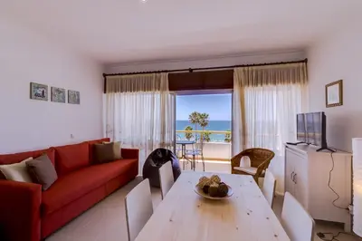 a living room with a red couch and a table at York - Sea view - Quarteira in Quarteira