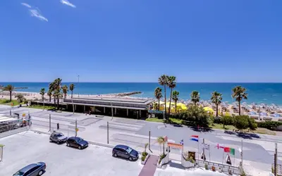 a parking lot at the beach with palm trees and the ocean at York - Sea view - Quarteira in Quarteira