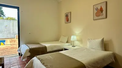 a hotel room with two beds and a window at El Gharbe by Check-in Portugal in Albufeira