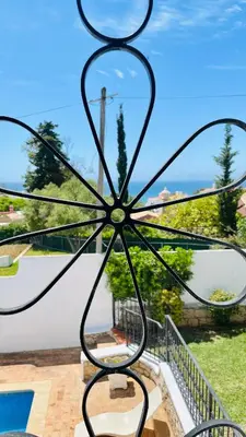 a metal sculpture of a flower on a patio at El Gharbe by Check-in Portugal in Albufeira