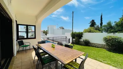 a patio with a wooden table and chairs on a balcony at El Gharbe by Check-in Portugal in Albufeira