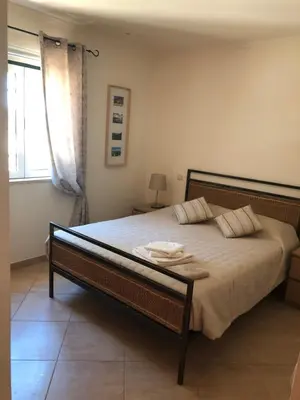 a bedroom with a bed and a window at Algarve Albufeira, quiet apart with pool at 10 mn walk from Praia da Falesia in Olhos de Água