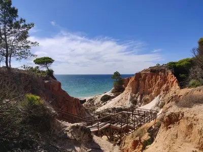 a staircase leading to the ocean on a cliff at Algarve Albufeira, quiet apart with pool at 10 mn walk from Praia da Falesia in Olhos de Água