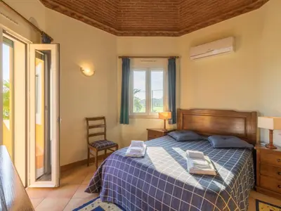 a bedroom with a bed with two towels on it at Casa Campo Spacious Living Private Pool Tranquil Setting in Guia