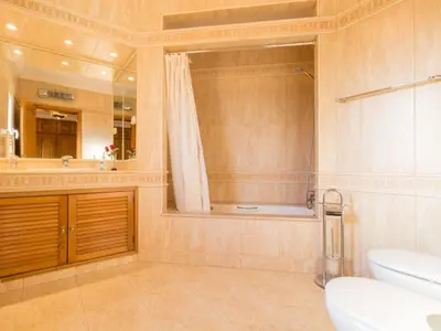 a bathroom with a toilet and a sink and a mirror at Casa Campo Spacious Living Private Pool Tranquil Setting in Guia