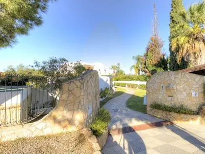 a stone wall with a gate and a pathway at Casa Vilamoura in Vilamoura