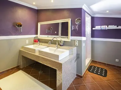a bathroom with two sinks and purple walls at Beautiful Loule Villa Villa Quinta Tropical Private Pool Air Conditioning in Loulé