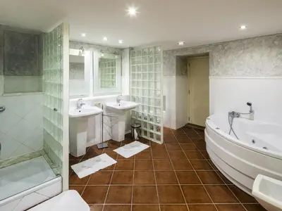 a bathroom with two sinks and a tub and a shower at Beautiful Loule Villa Villa Quinta Tropical Private Pool Air Conditioning in Loulé