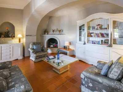 a living room with a couch and a fireplace at Beautiful Loule Villa Villa Quinta Tropical Private Pool Air Conditioning in Loulé