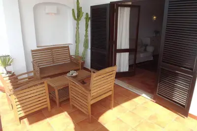 a dining room with a table and chairs in a room at Casa Nill - Apartamento na Praia do Forte de São João em Albufeira in Albufeira
