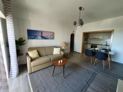 a living room with a couch and a table at Apartamento de Quarteira in Quarteira