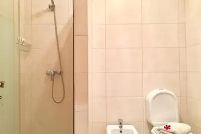 a bathroom with a shower with a toilet and a sink at Edificio Sao Joao das areias Strip l OURA in Albufeira