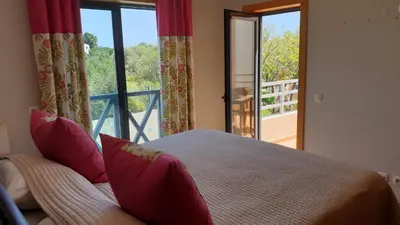 a bedroom with a bed and a large window at Luxury Villa Corcovada Nicole with privat heated pool in Albufeira