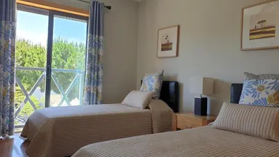a hotel room with two beds and a window at Luxury Villa Corcovada Nicole with privat heated pool in Albufeira