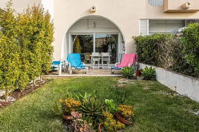 a backyard with two chairs and a table and chairs at Edif. Valemangude in Albufeira