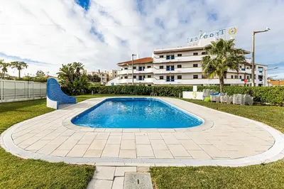 a swimming pool in front of a large building at Edif. Valemangude in Albufeira