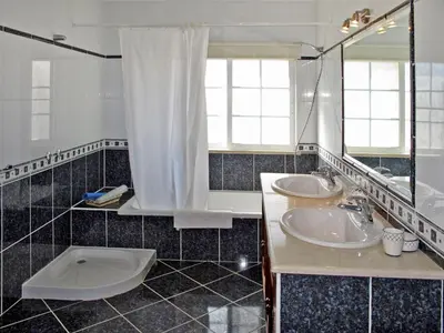 a bathroom with two sinks and a mirror at Holiday Home Vila Sol by Interhome in Cabeço de Câmara