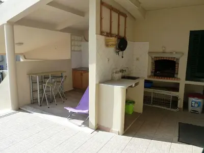 a kitchen with a table and chairs in a room at Villa Vacations House in Albufeira