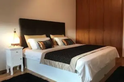 a bedroom with a large bed and a night stand at Colorful Cozy Apartment view in Albufeira
