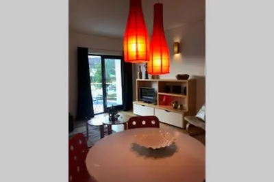 a dining room with a table and red lights at Colorful Cozy Apartment view in Albufeira