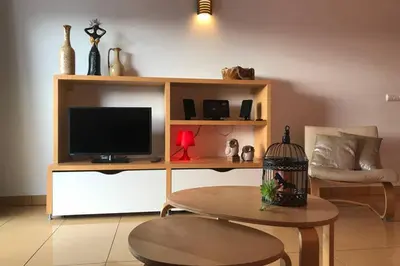 a living room with a tv and a table at Colorful Cozy Apartment view in Albufeira