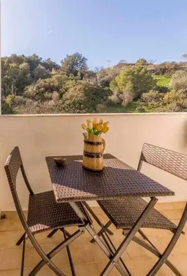 a table and two chairs with a vase on it at Albufeira Old Town Two bedroom Apartment Center in Albufeira