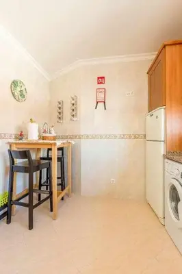 a kitchen with a table and a washing machine at Albufeira Old Town Two bedroom Apartment Center in Albufeira
