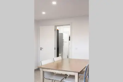 a dining room with a wooden table and chairs at REMODELED APARTMENT IN THE CITY CENTER. (FARO) in Faro